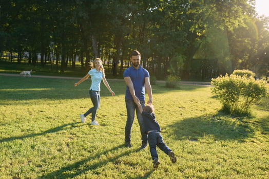 Parents play in the park with their son photo