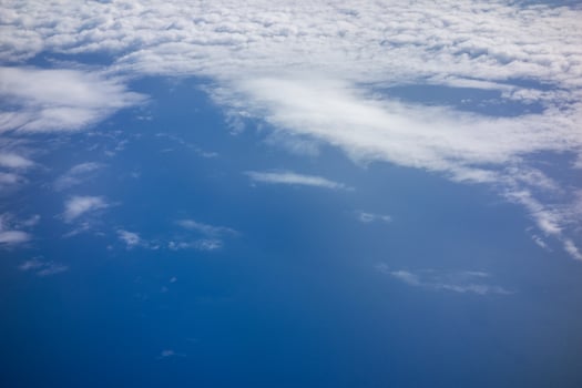 White fluffy clouds in a bright blue sky photo