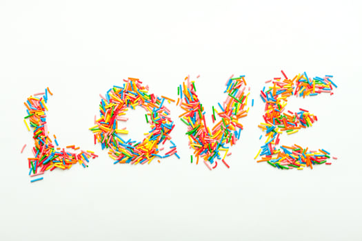 Minimalist concept flat lay word LOVE made of sugar sprinles. photo