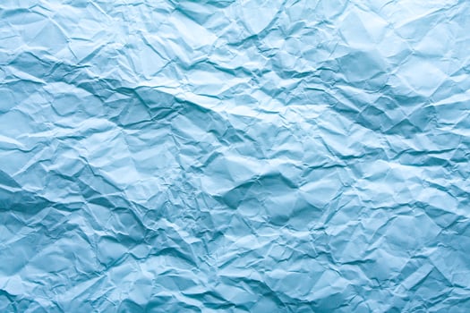 Blue wrinkled paper background with abstract seamless pattern. Crumpled paper texture. photo