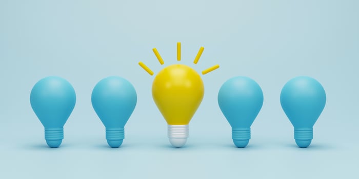 3d render 3d illustration. Yellow light bulb between the bulbs others on blue light background. Concepts of leadership, innovation, different creative idea and individuality. photo