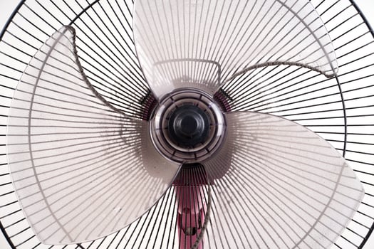 dirty electric fan on white background photo
