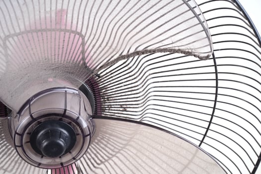 dirty electric fan on white background photo