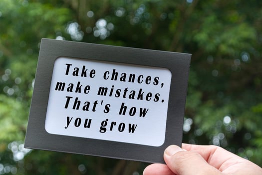 Motivational and inspirational quote on hands holding framed paper photo