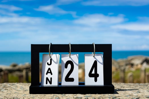 Jan 24 calendar date text on wooden frame with blurred background of ocean photo
