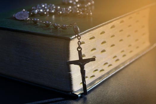 The cross over bible on wooden table with window light, vintage tone. photo