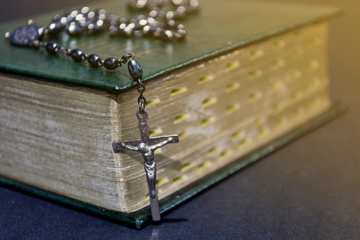 The cross over bible on wooden table with window light, vintage tone. photo