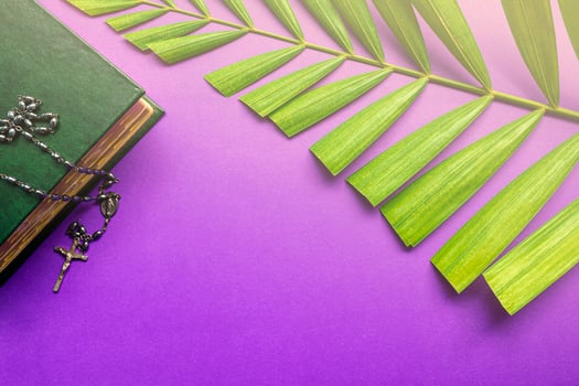 The Holy Bible, cross and palm leaves on purple background. Holy week concept. photo