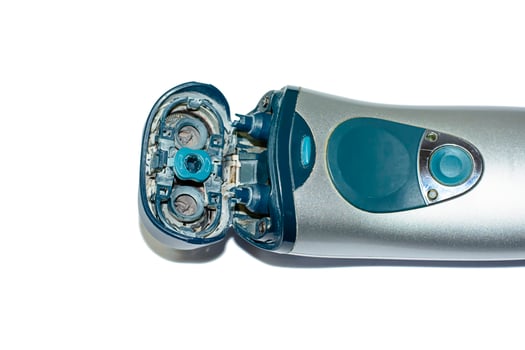 The old electric shaver on white background. photo