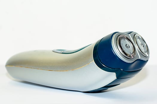 The old electric shaver on white background. photo