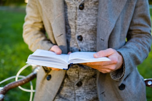 Young male hipster read book in autumn park photo