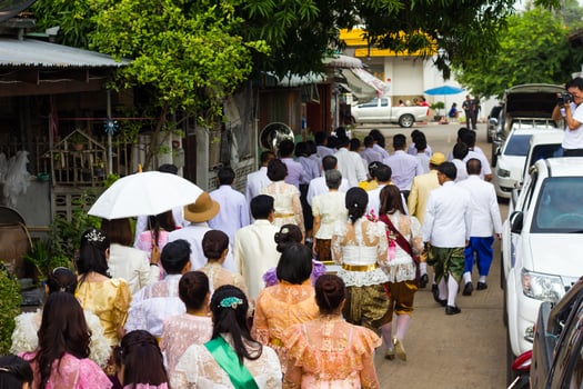 Rear view of the crowd wearing traditional Thai dress. photo