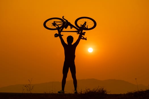 Silhouette of a cyclist on sunset in Thailand. photo