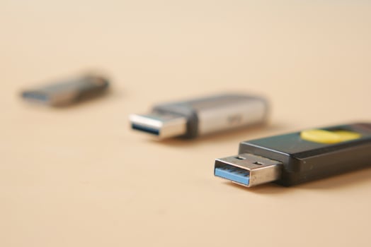 USB flash drive on blue background close up photo