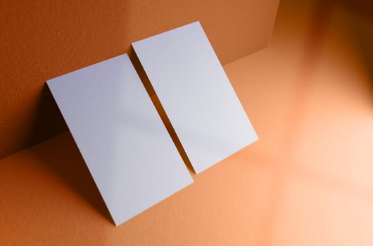 Double business card leaning against the wall mockup template photo