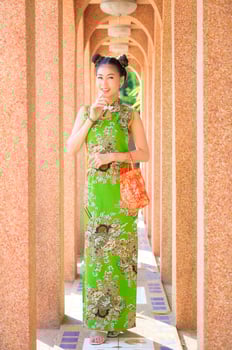 Asian beautiful woman photographed in Chinese national costumes for the Chinese New Year event photo