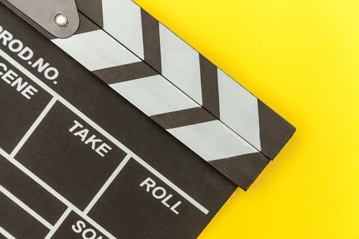 Filmmaker profession. Classic director empty film making clapperboard or movie slate isolated on yellow background. Video production film cinema industry concept. Flat lay top view copy space mock up. photo