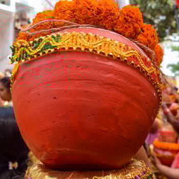 Women with Kalash on head during Jagannath Temple Mangal Kalash Yatra, Indian Hindu devotees carry earthen pots containing sacred water with a coconut on top photo