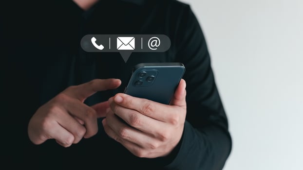 Hand of Businessman holding mobile smartphone. Contact Us, customer support concept. copy space. photo