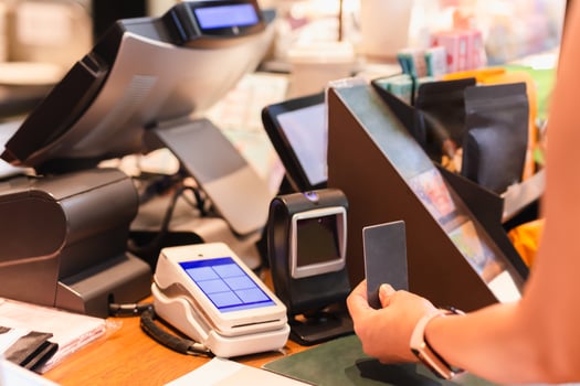 Woman paying bill through smart card in cafe. photo