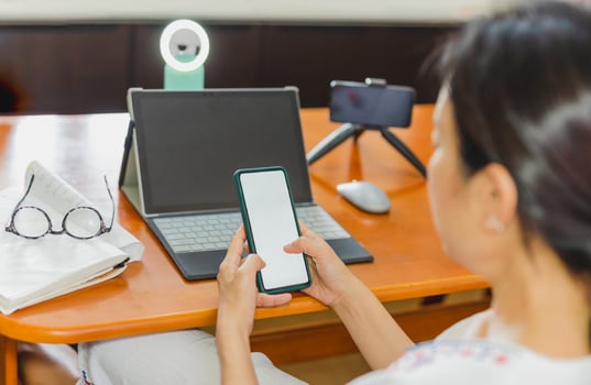Woman checking mobile phone before working online broadcasting live. photo
