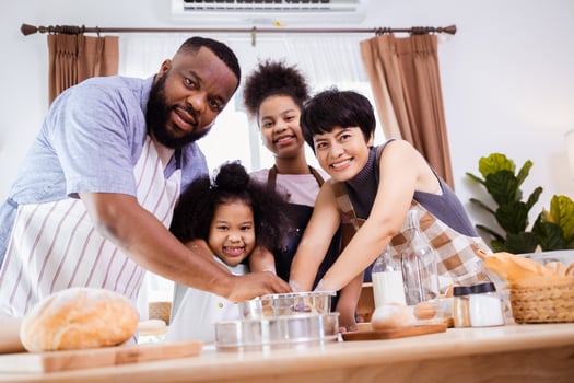 Happy African American family enjoy together while prepare the flour for making cookies at home photo