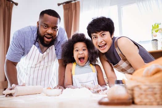 Happy African American family enjoy together while prepare the flour for making cookies at home photo