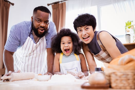 Happy African American family enjoy together while prepare the flour for making cookies at home photo