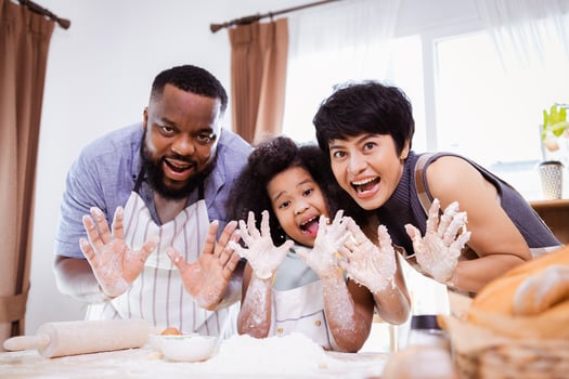 Happy African American family enjoy together while prepare the flour for making cookies at home photo