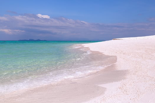 Beautiful ocean with white sandy beach and blue sky in tropical island. photo
