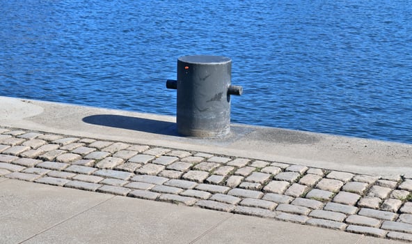 Different bollards and technical installations of vessel traffic at a port photo