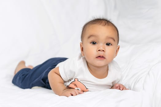 asian cute baby boy in bedroom with looking at camera photo
