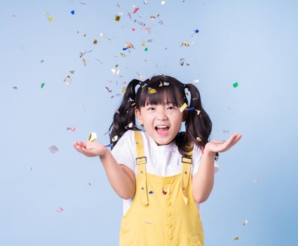 Portrait of Asian child posing on blue background photo
