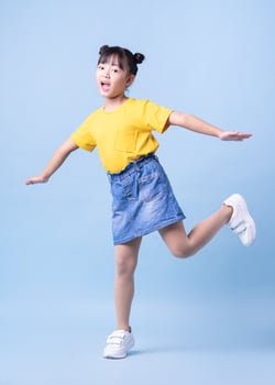 Image of Asian child posing on blue background photo