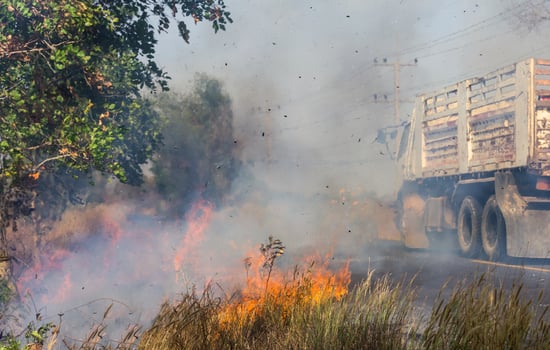 Grass fire smoke on the street. photo