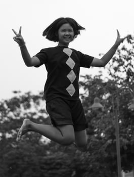 Black and white girl jumping happily. photo
