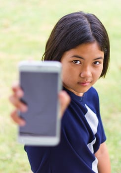 Young girl filed a mobile phone. photo