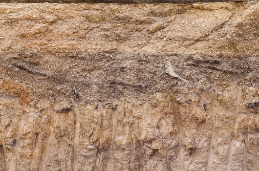 Soil below the gravel road. photo