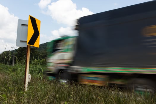 Signpost bends and trucks. photo
