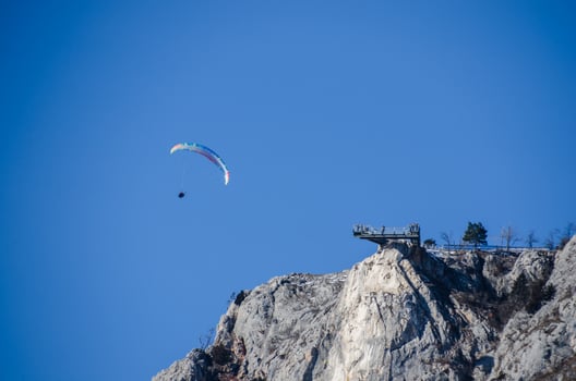 paragliders at rock wall photo