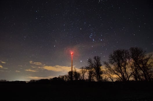 windmill at trees and starry sky photo