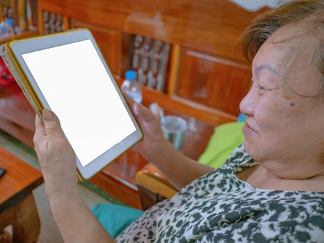 Old asian women very happy Look at the tablet photo