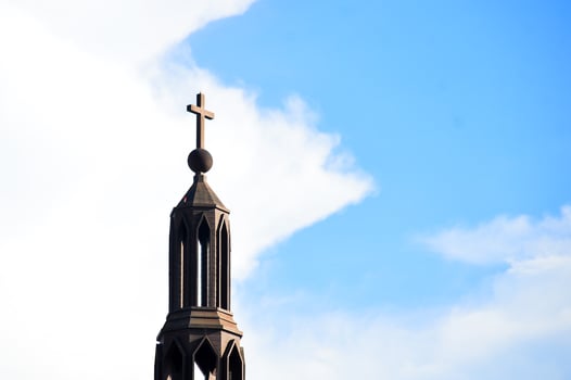 A large cross on a beautiful building photo