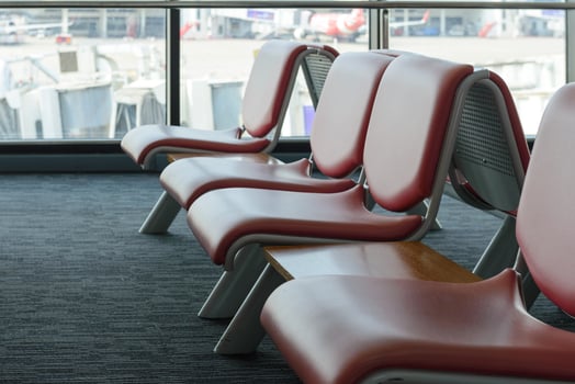 Departure lounge with empty chairs in the terminal of airport, waiting area photo