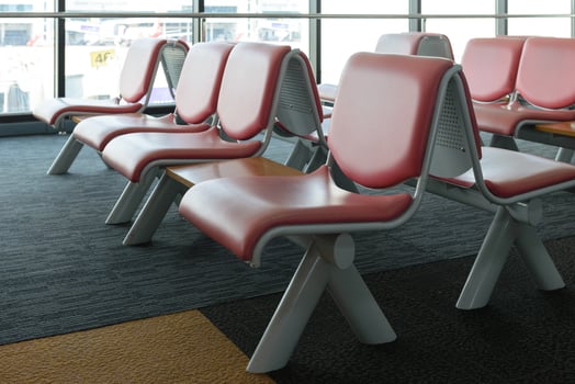 Departure lounge with empty chairs in the terminal of airport, waiting area photo