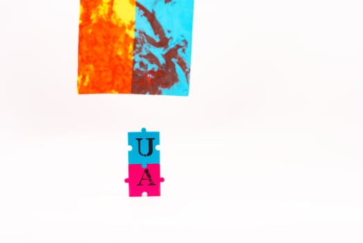 Flag of Ukraine with blood and puzzles with letters of Ukraine on a white back. As the symble of struggle photo