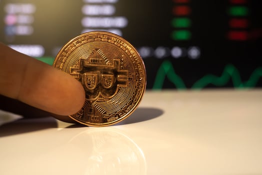 bitcoin coin on the background of exchange charts of currencies photo