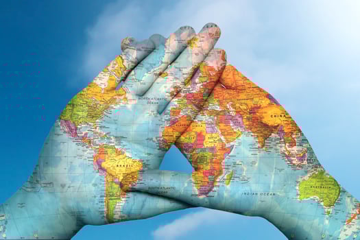 world map in hands against the sky photo