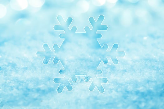 silhouette of a white snowflake on snow photo