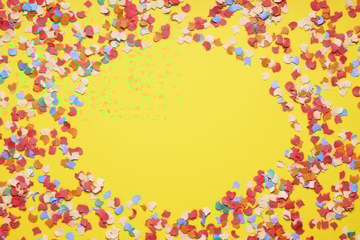confetti frame border on yellow paper background photo